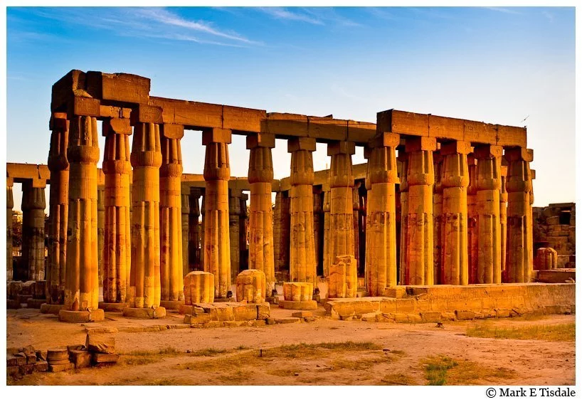 Beautiful golden hued photo of the ruins of Luxor Temple in Egypt