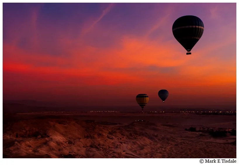 Valley of the Kings photo of hot air balloons in the pre-dawn skies - fiery red